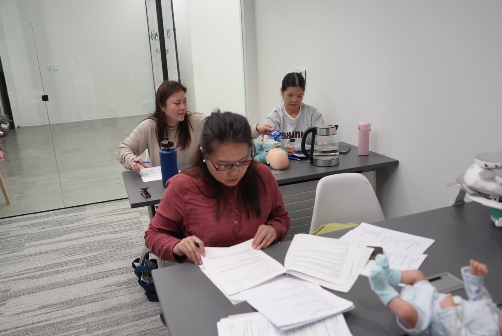 Trainees reviewing course materials during workshop
